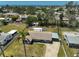 Aerial view of a cozy home featuring a driveway, lawn, carport, and well-kept surroundings at 4420 101St W St, Bradenton, FL 34210