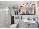 Bright bathroom featuring tiled walls, framed mirror, and glass-enclosed shower at 4420 101St W St, Bradenton, FL 34210