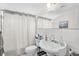 Bathroom featuring a shower, sink, mirror, and other necessary items at 4420 101St W St, Bradenton, FL 34210