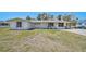 Quaint single-story home with a well-maintained front lawn, carport, and a classic white facade at 4420 101St W St, Bradenton, FL 34210