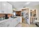 Well-equipped kitchen with a view of the wood-paneled living area and stainless steel appliances at 4420 101St W St, Bradenton, FL 34210