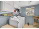 Functional laundry room with ample cabinet storage and a window for natural light at 4420 101St W St, Bradenton, FL 34210