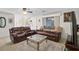 Inviting living room featuring comfortable brown leather seating and plenty of natural light at 4420 101St W St, Bradenton, FL 34210