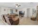 Spacious living room with comfortable leather furniture, a TV, and neutral decor, creating a relaxing space at 4420 101St W St, Bradenton, FL 34210