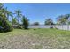 Large, well-maintained backyard with a fire pit and a white privacy fence at 4609 Talbot Pl, Sarasota, FL 34241