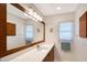 Bathroom vanity with a large mirror, ample lighting, and clean design at 4609 Talbot Pl, Sarasota, FL 34241