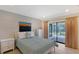 Inviting bedroom with natural light flowing from the sliding doors that lead to the screened patio and pool at 4609 Talbot Pl, Sarasota, FL 34241