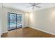 Light-filled bedroom with wood floors and sliding doors leading to the screened pool area at 4609 Talbot Pl, Sarasota, FL 34241