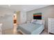 Comfortable bedroom featuring a neutral color scheme and a stylish accent wall with a bathroom just off the hall at 4609 Talbot Pl, Sarasota, FL 34241