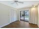 Bright bedroom with wood floors, a ceiling fan, closet with a view of the screened pool area at 4609 Talbot Pl, Sarasota, FL 34241