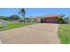 Charming single-story home with a well-manicured lawn and a spacious driveway leading to a two-car garage at 4609 Talbot Pl, Sarasota, FL 34241