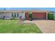 Attractive home featuring neat landscaping, a tidy lawn, and a spacious driveway leading to an attached garage at 4609 Talbot Pl, Sarasota, FL 34241