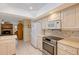 Functional kitchen with white appliances, ample counter space, and a view into an adjacent living space at 4609 Talbot Pl, Sarasota, FL 34241