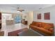 Bright living room with tiled floors, ceiling fan, and sliding glass doors to the outdoor area at 4609 Talbot Pl, Sarasota, FL 34241