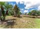 Lush backyard featuring tropical landscaping and a serene pond view at 4610 Runabout Way, Bradenton, FL 34203