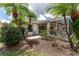 Relaxing backyard space with mature trees, a screened porch, and charming outdoor seating at 4610 Runabout Way, Bradenton, FL 34203