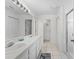 Bright bathroom with double vanity, tiled floors, and walk-in shower offering a clean and modern design at 4610 Runabout Way, Bradenton, FL 34203
