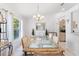 Bright dining room with large window, elegant chandelier, and seating for six at 4610 Runabout Way, Bradenton, FL 34203
