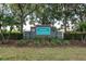 Elegant community entrance sign 'Sabal Harbour' surrounded by landscaping and mature trees at 4610 Runabout Way, Bradenton, FL 34203