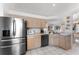 Modern kitchen with stainless steel appliances, light wood cabinets, and ample counter space at 4610 Runabout Way, Bradenton, FL 34203