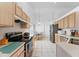 Well-lit kitchen with light wood cabinets, stainless steel appliances, and a casual dining area at 4610 Runabout Way, Bradenton, FL 34203