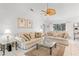 Cozy living room with comfortable sofas, neutral decor, and tile flooring at 4610 Runabout Way, Bradenton, FL 34203