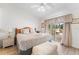 Comfortable bedroom featuring a large bed, neutral tones, and a sliding glass door leading to the outdoors at 4610 Runabout Way, Bradenton, FL 34203
