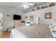 Well-lit bedroom featuring a bed, TV, and decorative shelving, perfect for a relaxing retreat at 4610 Runabout Way, Bradenton, FL 34203