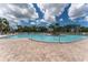 Community pool featuring clear blue water, surrounding palm trees and ample lounge chairs for relaxation at 4610 Runabout Way, Bradenton, FL 34203
