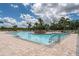 Community pool surrounded by lounge chairs and lush greenery at 4610 Runabout Way, Bradenton, FL 34203