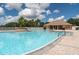 Large community pool area with a shaded cabana, lounge chairs, and clear blue water for residents to enjoy at 4610 Runabout Way, Bradenton, FL 34203