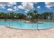 A community pool with palm trees, lounge chairs, and stainless steel handrails for easy access at 4610 Runabout Way, Bradenton, FL 34203