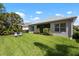 A spacious, green backyard with well-maintained lawn and a screened lanai, perfect for outdoor enjoyment at 4814 Lake Breeze Ter, Sarasota, FL 34243