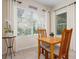 Cozy breakfast nook with large windows and a 'Bonjour' sign at 4814 Lake Breeze Ter, Sarasota, FL 34243