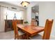 Cozy dining area with a table set for four, next to a window with decorative items at 4814 Lake Breeze Ter, Sarasota, FL 34243