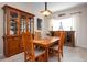 Dining area with a wooden table, upholstered chairs, and view of display cabinet at 4814 Lake Breeze Ter, Sarasota, FL 34243