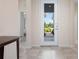 Bright entryway featuring neutral walls, tiled floor, and a view of the home's front door at 4814 Lake Breeze Ter, Sarasota, FL 34243