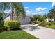 Beautifully landscaped one-story home featuring a wide driveway and attached two car garage at 4814 Lake Breeze Ter, Sarasota, FL 34243