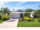 Charming single-story home featuring manicured landscaping and an attached two-car garage at 4814 Lake Breeze Ter, Sarasota, FL 34243