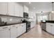 Well-lit kitchen boasts ample white cabinetry and stainless steel appliances at 4814 Lake Breeze Ter, Sarasota, FL 34243