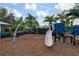 The community playground has a slide and a rope climbing apparatus surrounded by mulch at 4814 Lake Breeze Ter, Sarasota, FL 34243