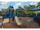 Brightly colored community playground with slide, climbing structure and shade near rope swing at 4814 Lake Breeze Ter, Sarasota, FL 34243