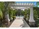 A charming pergola covered entranceway leads to the community pool area at 4814 Lake Breeze Ter, Sarasota, FL 34243