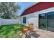 Quaint backyard with small brick patio, dining set, green grass, and a privacy fence at 4838 San Ortebello Dr, Bradenton, FL 34208
