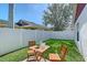 Cozy backyard with lush green grass and a charming outdoor dining set for relaxation at 4838 San Ortebello Dr, Bradenton, FL 34208