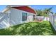 Spacious backyard with lush grass, white privacy fence, and sliding door access to the house at 4838 San Ortebello Dr, Bradenton, FL 34208