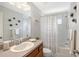 Bright bathroom with a single sink vanity, mirror, and shower-tub combination at 4838 San Ortebello Dr, Bradenton, FL 34208