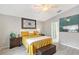 Bedroom features wood-look floors and a decorative wall hanging above the cream colored headboard at 4838 San Ortebello Dr, Bradenton, FL 34208