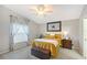 Cozy bedroom featuring wood-look floors, ceiling fan, and decorative wall art above the headboard at 4838 San Ortebello Dr, Bradenton, FL 34208