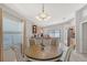 Dining area with wood floors, with a view to the kitchen and stainless steel appliances at 4838 San Ortebello Dr, Bradenton, FL 34208